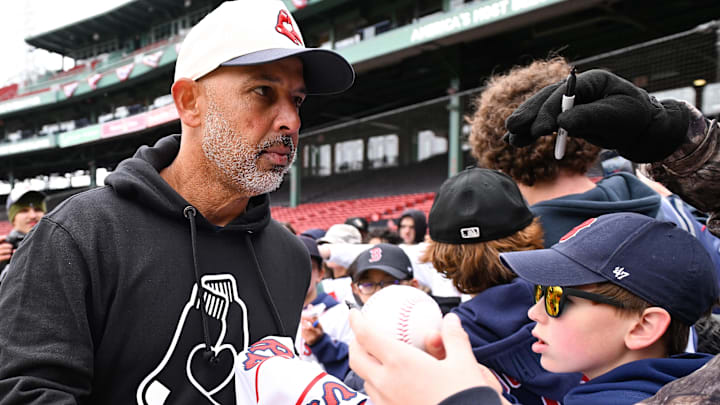 Apr 4, 2026; Foxborough, Massachusetts, USA; Boston Red Sox manager Alex Cora (13) signs autographs for fans before a game against the San Diego Padres at Fenway Park. Mandatory Credit: Eric Canha-Imagn Images