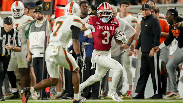 Indiana Hoosiers wide receiver Omar Cooper Jr. (3) runs down the sideline past Miami (FL) Hurricanes defenders Monday, Jan. 19, 2026, during the College Football Playoff National Championship college football game at Hard Rock Stadium in Miami Gardens.