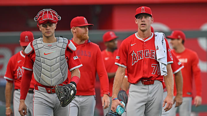 Sep 2, 2025; Kansas City, Missouri, USA;  Los Angeles Angels starting pitcher Mitch Farris (70) walks to the dugout with Los Angeles Angels catcher Logan O'Hoppe (14) before a game against the Kansas City Royals at Kauffman Stadium. Mandatory Credit: Peter Aiken-Imagn Images