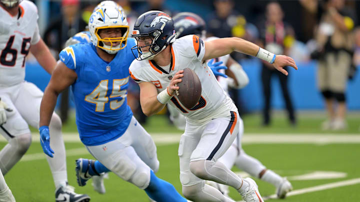 Sep 21, 2025; Inglewood, California, USA;  Denver Broncos quarterback Bo Nix (10) is pressured by Los Angeles Chargers linebacker Tuli Tuipulotu (45) in the second half SoFi Stadium. Mandatory Credit: Jayne Kamin-Oncea-Imagn Images