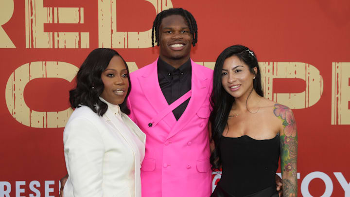 Colorado Buffaloes wide receiver Travis Hunter with his mother Ferrante Harris and his fiancee Leanna Lenee on the red carpet before the 2025 NFL Draft at Lambeau Field.