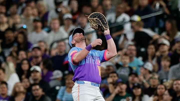 Sep 19, 2025; Denver, Colorado, USA; Colorado Rockies first baseman Blaine Crim (16) makes a catch in the sixth inning against the Los Angeles Angels at Coors Field. 