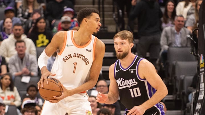 Feb 22, 2024; Sacramento, California, USA; San Antonio Spurs center Victor Wembanyama (1) controls the ball against Sacramento Kings forward Domantas Sabonis (10) during the first quarter at Golden 1 Center. Mandatory Credit: Ed Szczepanski-Imagn Images
