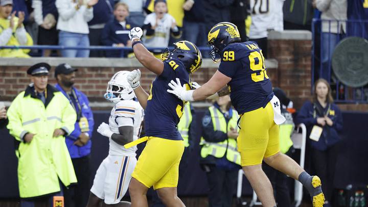 Sep 19, 2026; Ann Arbor, Michigan, USA; Michigan Wolverines defensive tackle Jonah Lea'ea (91) celebrates with Bobby Kanka (99) after returning an interception for a touchdown against the Texas El Paso Miners during the third quarter at Michigan Stadium. Mandatory Credit: Rick Osentoski-Imagn Images Sep 19, 2026; Ann Arbor, Michigan, USA; Michigan Wolverines defensive tackle Jonah Lea'ea (91) celebrates with Bobby Kanka (99) after returning an interception for a touchdown against the Texas El Paso Miners during the third quarter at Michigan Stadium. Mandatory Credit: Rick Osentoski-Imagn Images