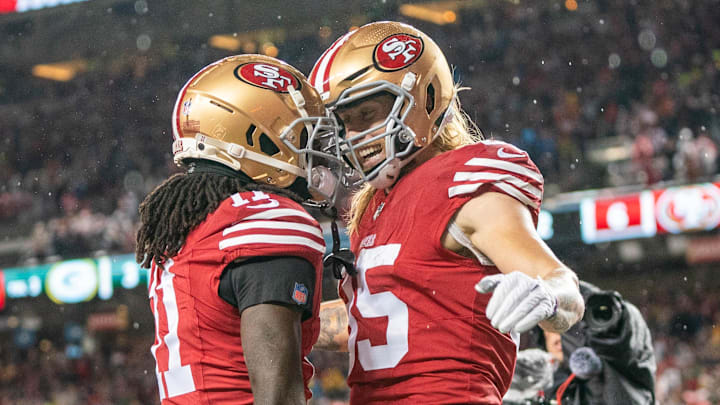 January 20, 2024; Santa Clara, CA, USA; San Francisco 49ers tight end George Kittle (85) is congratulated by wide receiver Brandon Aiyuk (11) after scoring a touchdown during the second quarter in a 2024 NFC divisional round game against the Green Bay Packers at Levi's Stadium. Mandatory Credit: Kyle Terada-Imagn Images