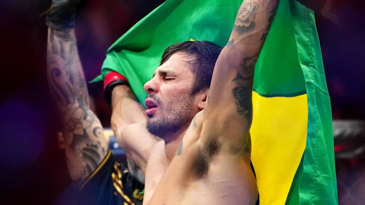 Dec 16, 2023; Las Vegas, Nevada, USA; Alexandre Pantoja (red gloves) reacts after defeating Brandon