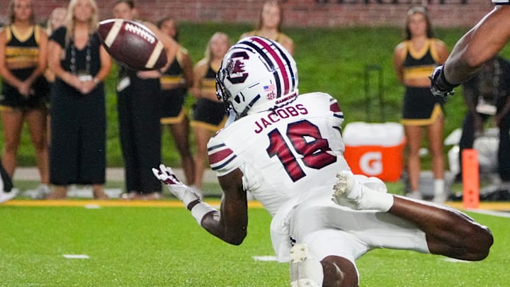 Sep 20, 2025; Columbia, Missouri, USA; South Carolina Gamecocks wide receiver Vandrevius Jacobs (19) makes a diving catch as Missouri Tigers cornerback Stephen Hall (0) looks on during the second half of the game at Faurot Field at Memorial Stadium. Mandatory Credit: Denny Medley-Imagn Images