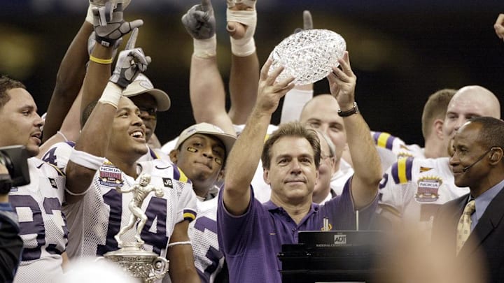 Jan. 4, 2004; New Orleans, LA, USA; Nick Saban, in blue, lifts the BCS National Championship Trophy after the Tigers' 21-14 victory over Oklahoma in the Nokia Sugar Bowl; Mandatory credit: Robert Deutsch-USA TODAY NETWORK

 
