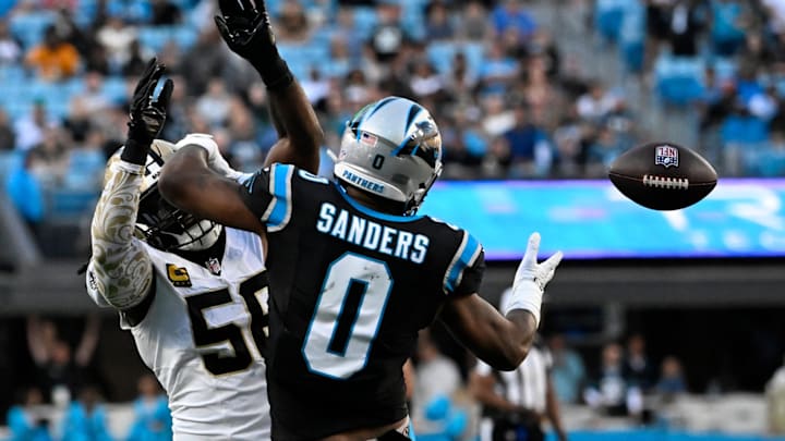 Nov 3, 2024; Charlotte, North Carolina, USA; Carolina Panthers tight end Ja'Tavion Sanders (0) attempts to catch the ball as New Orleans Saints linebacker Demario Davis (56) defends in the fourth qarter at Bank of America Stadium. 