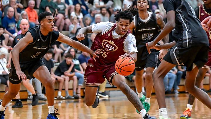 Team Faygo and Michigan State's Jasiah Jervis, center, moves through the Team Motorcars defense during the Moneyball Pro-Am on Tuesday, June 23, 2026, at Holt High School.