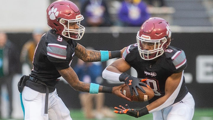 Louisville's quarterback Zavier Hunt (9) hands off to Zaiden Jernigan (8) during play against Louisville in the MHSAA 4A championship game in Hattiesburg, Miss., Saturday, Dec. 7, 2024.