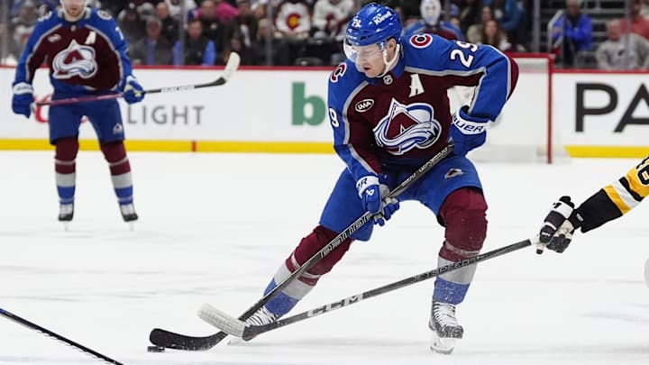 Mar 4, 2025; Denver, Colorado, USA; Colorado Avalanche center Nathan MacKinnon (29) controls the puck in the second period against the Pittsburgh Penguins at Ball Arena. Mandatory Credit: Ron Chenoy-Imagn Images