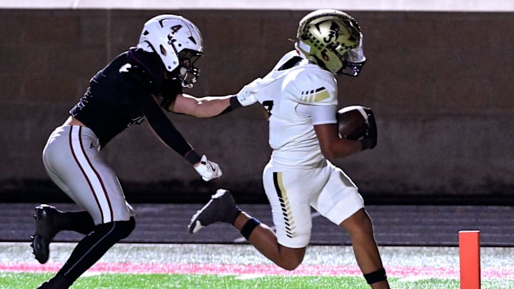 Klondike’s Trenton Thixton unsuccessfully attempts to pull Jayton’s Lorenzo Vargas away from the goal line during the Class 1A Division II state semifinal six-man football game at Wolf Stadium in Colorado City Friday Dec. 5, 2025. Final score was 64-19, Jayton.