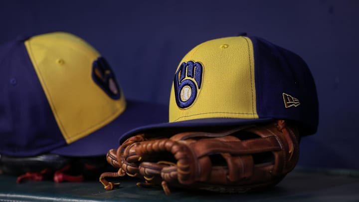 Jul 28, 2023; Atlanta, Georgia, USA; A detailed view of a Milwaukee Brewers hat and glove on the bench against the Atlanta Braves in the second inning at Truist Park. Mandatory Credit: Brett Davis-Imagn Images