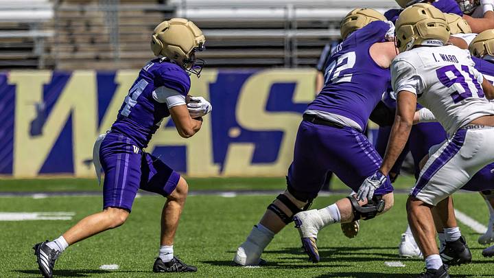 Brian Bonner Jr. runs behind the blocking of John Mills during a spring practice. Brian Bonner Jr. runs behind the blocking of John Mills during a spring practice.