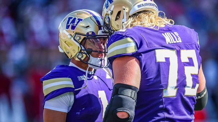 Demond Williams Jr. and John Mills have a UW game-day moment. 