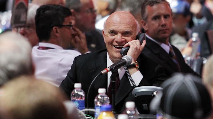 Jun 30, 2013; Newark, NJ, USA; New Jersey Devils general manager Lou Lamoriello speaks on the phone during the 2013 NHL Draft at the Prudential Center. Mandatory Credit: Ed Mulholland-Imagn Images