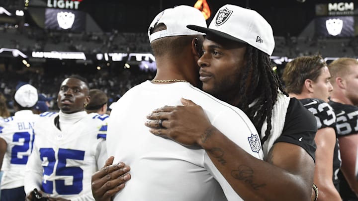 Dallas Cowboys quarterback Dak Prescott hugs Las Vegas Raiders wide receiver Davante Adams after game. 