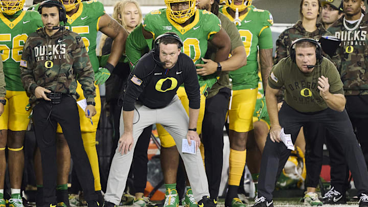 Nov 9, 2024; Eugene, Oregon, USA; Oregon Ducks head coach Dan Lanning, center, watches the defense during the second half against the Maryland Terrapins at Autzen Stadium. 