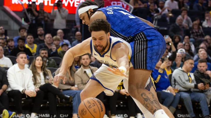 Jan 2, 2024; San Francisco, California, USA; Orlando Magic forward Paolo Banchero (5) and Golden State Warriors guard Klay Thompson (11) battle for a loose ball during the third quarter at Chase Center. Jan 2, 2024; San Francisco, California, USA; Orlando Magic forward Paolo Banchero (5) and Golden State Warriors guard Klay Thompson (11) battle for a loose ball during the third quarter at Chase Center.