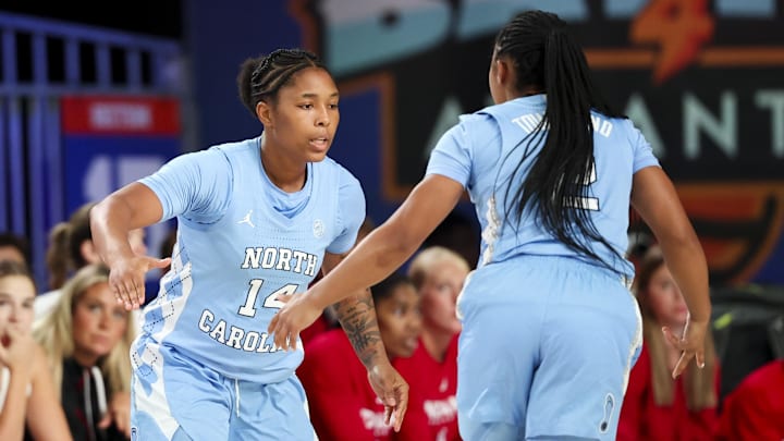 Nov 25, 2024; Paradise Island, Bahamas, BHS; North Carolina Tar Heels guard Trayanna Crisp (14) celebrates with North Carolina Tar Heels guard Grace Townsend (2) during the first half against the Indiana Hoosiers at the Atlantis Resort. Mandatory Credit: Kevin Jairaj-Imagn Images