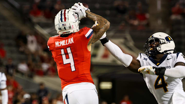 Oct 26, 2024; Tucson, Arizona, USA; Arizona Wildcats wide receiver Tetairoa McMillan (4) catches a long pass while West Virginia Mountaineers linebacker Trey Lathan (4) fails to defend against him during the fourth quarter at Arizona Stadium