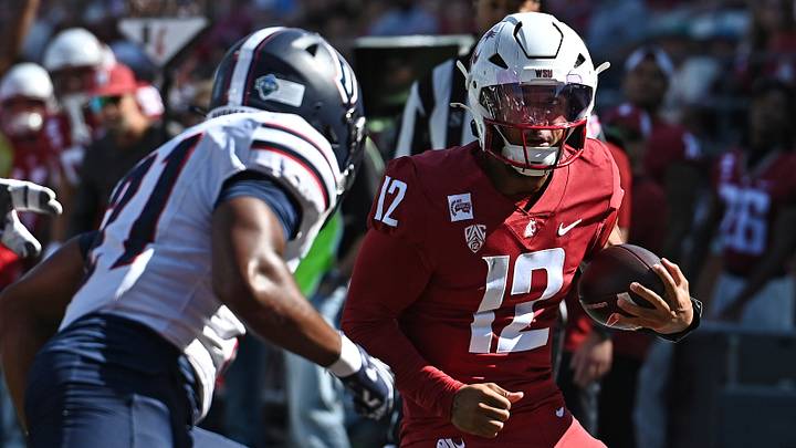 Washington State Cougars quarterback Caden Pinnick (12) is hit out of bounds by Duquesne Dukes defensive back Caleb Jones (21) during the first half at Gesa Field at Martin Stadium. Washington State Cougars quarterback Caden Pinnick (12) is hit out of bounds by Duquesne Dukes defensive back Caleb Jones (21) during the first half at Gesa Field at Martin Stadium.