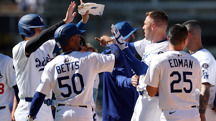 Jul 23, 2025; Los Angeles, California, USA;  Los Angeles Dodgers first baseman Freddie Freeman (5) celebrates with designated hitter Shohei Ohtani (17,left) and shortstop Mookie Betts (50) after hitting a game winning RBI single in the ninth inning against the Minnesota Twins at Dodger Stadium. Mandatory Credit: Kiyoshi Mio-Imagn Images