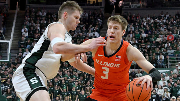 Jan 19, 2025; East Lansing, Michigan, USA;  Michigan State Spartans forward Jaxon Kohler (0) defends Illinois Fighting Illini forward Ben Humrichous (3) during the first half at Jack Breslin Student Events Center. Mandatory Credit: Dale Young-Imagn Images