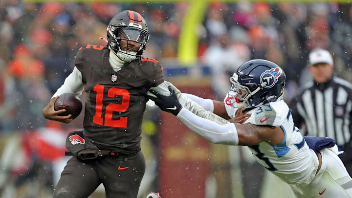 Cleveland Browns quarterback Shedeur Sanders (12) picks up a first down on his feet ahead of Tennessee Titans linebacker Cedric Gray (33) during the first half of an NFL football game at Huntington Bank Field, Dec. 7, 2025, in Cleveland, Ohio. Cleveland Browns quarterback Shedeur Sanders (12) picks up a first down on his feet ahead of Tennessee Titans linebacker Cedric Gray (33) during the first half of an NFL football game at Huntington Bank Field, Dec. 7, 2025, in Cleveland, Ohio.