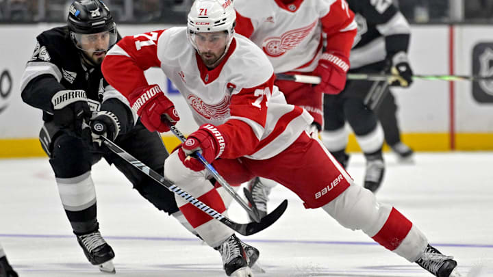 Nov 16, 2024; Los Angeles, California, USA; Detroit Red Wings center Dylan Larkin (71) controls the puck from Los Angeles Kings center Phillip Danault (24) in the third period at Crypto.com Arena. Mandatory Credit: Jayne Kamin-Oncea-Imagn Images