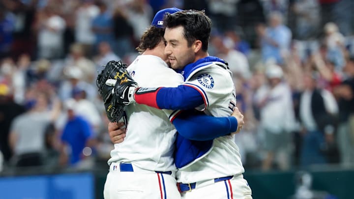 Texas Rangers relief pitcher Jakob Junis celebrates with Texas Rangers catcher Kyle Higashioka.