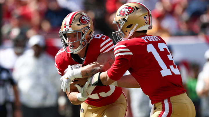 Nov 10, 2024; Tampa, Florida, USA; San Francisco 49ers quarterback Brock Purdy (13) hands off to running back Christian McCaffrey (23) against the Tampa Bay Buccaneers in the first quarter at Raymond James Stadium. Mandatory Credit: Nathan Ray Seebeck-Imagn Images
