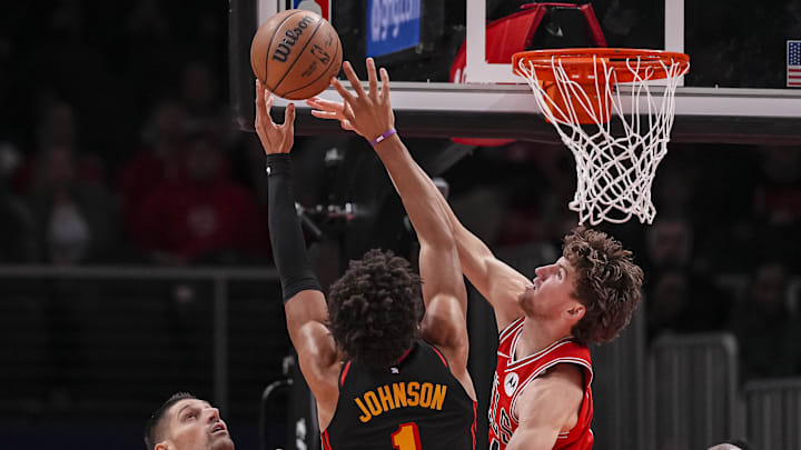 Dec 21, 2025; Atlanta, Georgia, USA; Chicago Bulls forward Matas Buzelis (14) defends a shot by Atlanta Hawks forward Jalen Johnson (1) during the second half at State Farm Arena. Mandatory Credit: Dale Zanine-Imagn Images