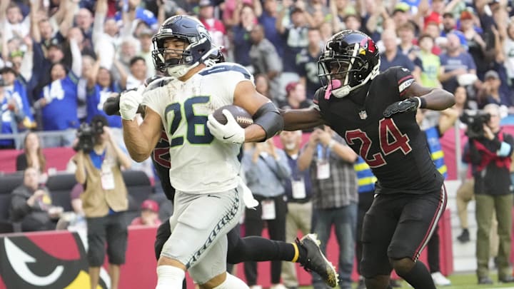 Seattle Seahawks running back Zach Charbonnet (26) runs for a touchdown against Arizona Cardinals cornerback Starling Thomas V (24) during the second quarter at State Farm Stadium in Glendale on Dec. 8, 2024.