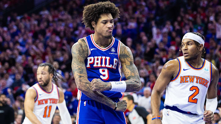 Apr 25, 2024; Philadelphia, Pennsylvania, USA; Philadelphia 76ers guard Kelly Oubre Jr. (9) reacts in front of New York Knicks guard Miles McBride (2) and guard Jalen Brunson (11) after scoring during the second half of game three of the first round for the 2024 NBA playoffs at Wells Fargo Center. Mandatory Credit: Bill Streicher-Imagn Images