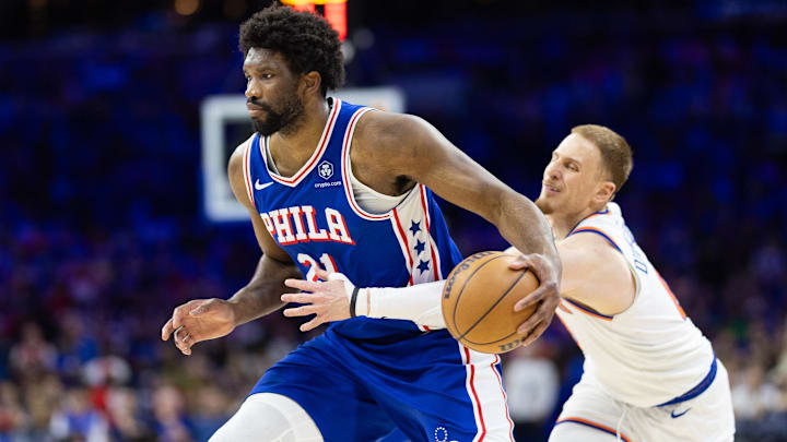 May 2, 2024; Philadelphia, Pennsylvania, USA; Philadelphia 76ers center Joel Embiid (21) drives against New York Knicks guard Donte DiVincenzo (0) during the second half of game six of the first round for the 2024 NBA playoffs at Wells Fargo Center. Mandatory Credit: Bill Streicher-Imagn Images