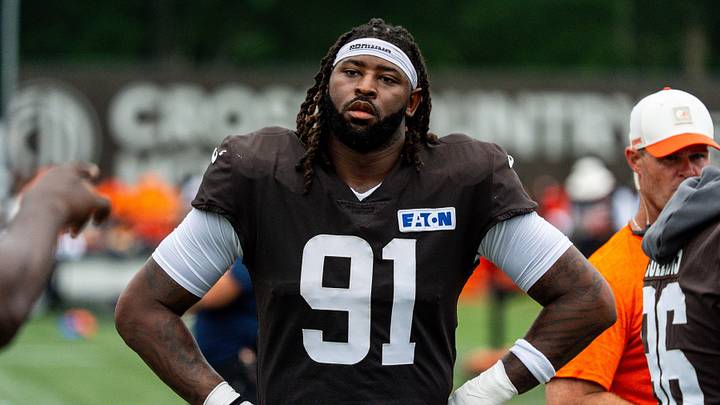 Cleveland Browns defensive end Alex Wright (91) takes in drill instruction during day 12 of training camp, Aug. 11, 2026, in Berea, Ohio.