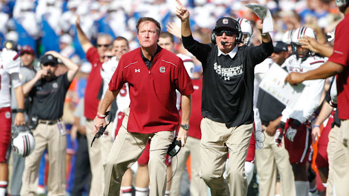 Nov 15, 2014; Gainesville, FL, USA; South Carolina Gamecocks head coach Steve Spurrier and co-offensive coordinator Steve Spurrier Jr. react against the Florida Gators during the second half at Ben Hill Griffin Stadium. South Carolina Gamecocks defeated the Florida Gators 23-20 in overtime. Mandatory Credit: Kim Klement-Imagn Images