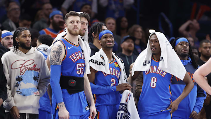 Feb 10, 2025; Oklahoma City, Oklahoma, USA; Oklahoma City Thunder guard Isaiah Joe (11), center Isaiah Hartenstein (55), forward Chet Holmgren (7), guard Shai Gilgeous-Alexander (2), forward Jalen Williams (8) and guard Luguentz Dort (5) watch the end of a game against the New Orleans Pelicans at Paycom Center. Mandatory Credit: Alonzo Adams-Imagn Images