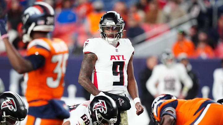 Nov 17, 2024; Denver, Colorado, USA; Atlanta Falcons quarterback Michael Penix Jr. (9) at the line of scrimmage in the fourth quarter against the Denver Broncos  at Empower Field at Mile High. Mandatory Credit: Ron Chenoy-Imagn Images