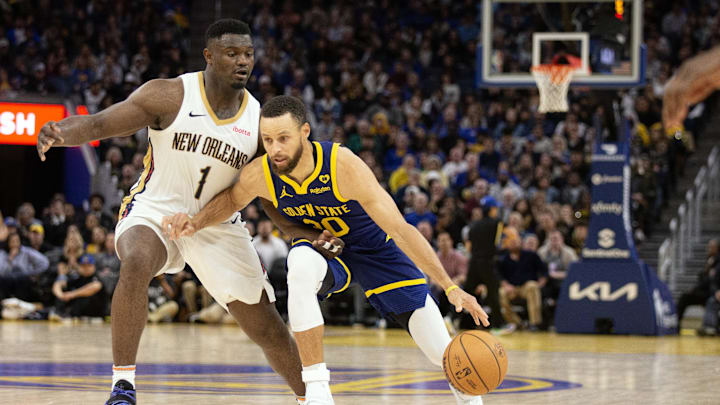 Golden State Warriors guard Stephen Curry (30) dribbles around New Orleans Pelicans forward Zion Williamson (1) during the fourth quarter at Chase Center. Mandatory Credit: D. Ross Cameron-Imagn Images