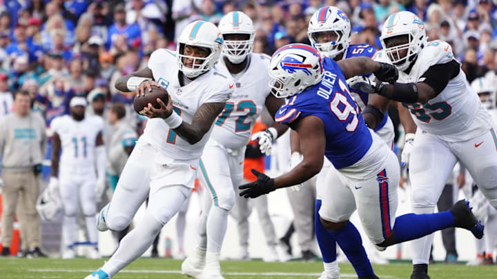 Miami Dolphins quarterback Tua Tagovailoa (1) runs with the ball against Buffalo Bills defensive tackle Ed Oliver (91) during the second half at Highmark Stadium. 
