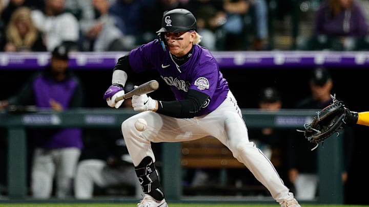 Apr 8, 2025; Denver, Colorado, USA; Colorado Rockies right fielder Zac Veen (13) bunts for his first career hit in the sixth inning against the Milwaukee Brewers at Coors Field. Mandatory Credit: Isaiah J. Downing-Imagn Images