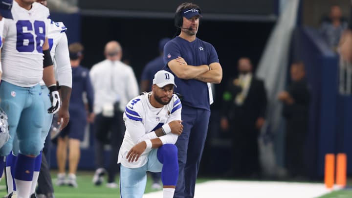 Dallas Cowboys quarterback Dak Prescott and offensive coordinator  Brian Schottenheimer watch a play in the game against the Jacksonville Jaguars.
