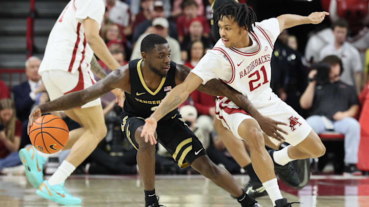 Vanderbilt Commodores guard Duke Miles (2) drives against Arkansas Razorbacks guard D.J. Wagner (21) during the first half at Bud Walton Arena. 