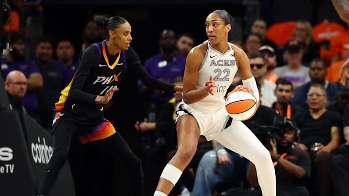 Oct 8, 2025; Phoenix, Arizona, USA; Las Vegas Aces center A'ja Wilson (22) against Phoenix Mercury forward DeWanna Bonner (14) during game three of the 2025 WNBA Finals at PHX Arena. Mandatory Credit: Mark J. Rebilas-Imagn Images