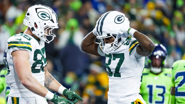 Green Bay Packers wide receiver Romeo Doubs (87) celebrates with tight end Tucker Kraft (85) after catching a touchdown pass.