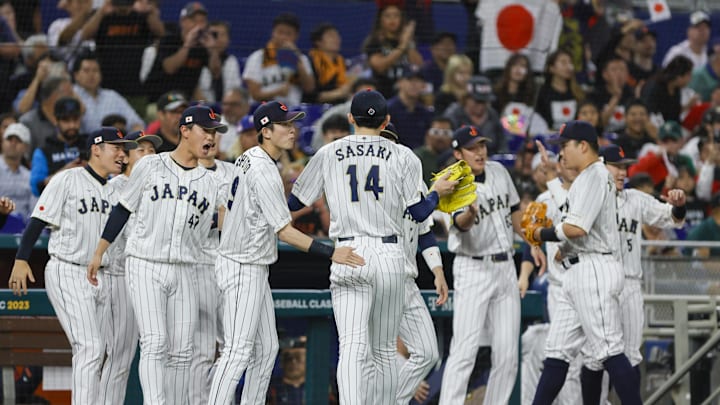 Mar 20, 2023; Miami, Florida, USA; Japan starting pitcher Roki Sasaki (14) celebrates with teammates after the first inning against Mexico at LoanDepot Park.