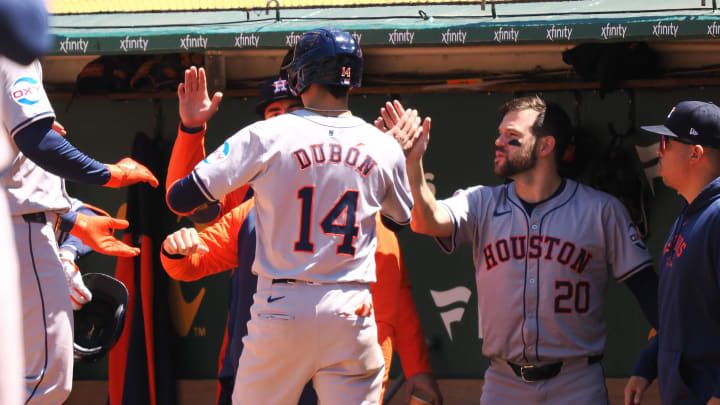 May 25, 2024; Oakland, California, USA; Houston Astros second baseman Mauricio Dubon (14) high fives teammates after scoring a run Oakland Athletics during the sixth inning at Oakland-Alameda County Coliseum. May 25, 2024; Oakland, California, USA; Houston Astros second baseman Mauricio Dubon (14) high fives teammates after scoring a run Oakland Athletics during the sixth inning at Oakland-Alameda County Coliseum.
